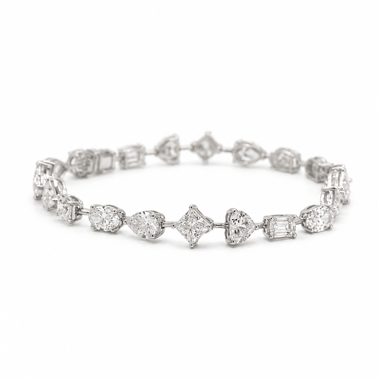 Multi-shape diamond tennis bracelet with oval, princess, emerald, pear and heart-cut diamonds in 18k white gold by EMBLUME