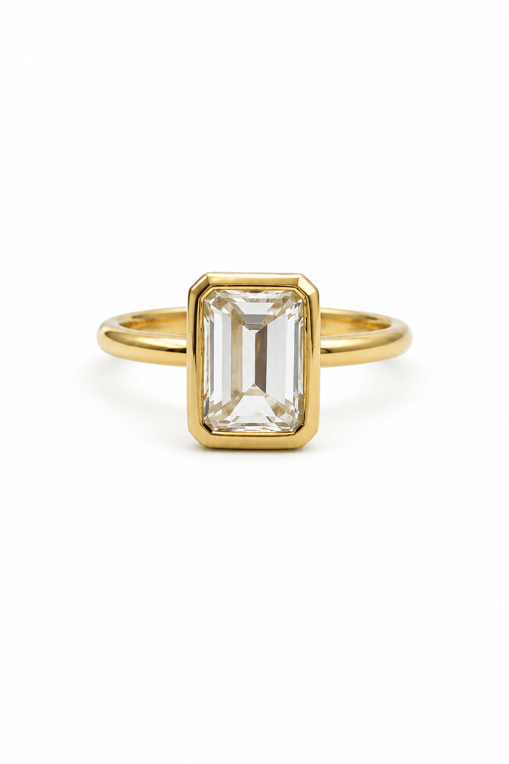 Emerald cut diamond bezel ring in yellow gold by EMBLUME
