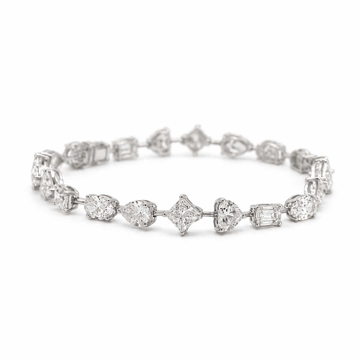 Multi-shape diamond tennis bracelet with oval, princess, emerald, pear and heart-cut diamonds in 18k white gold by EMBLUME