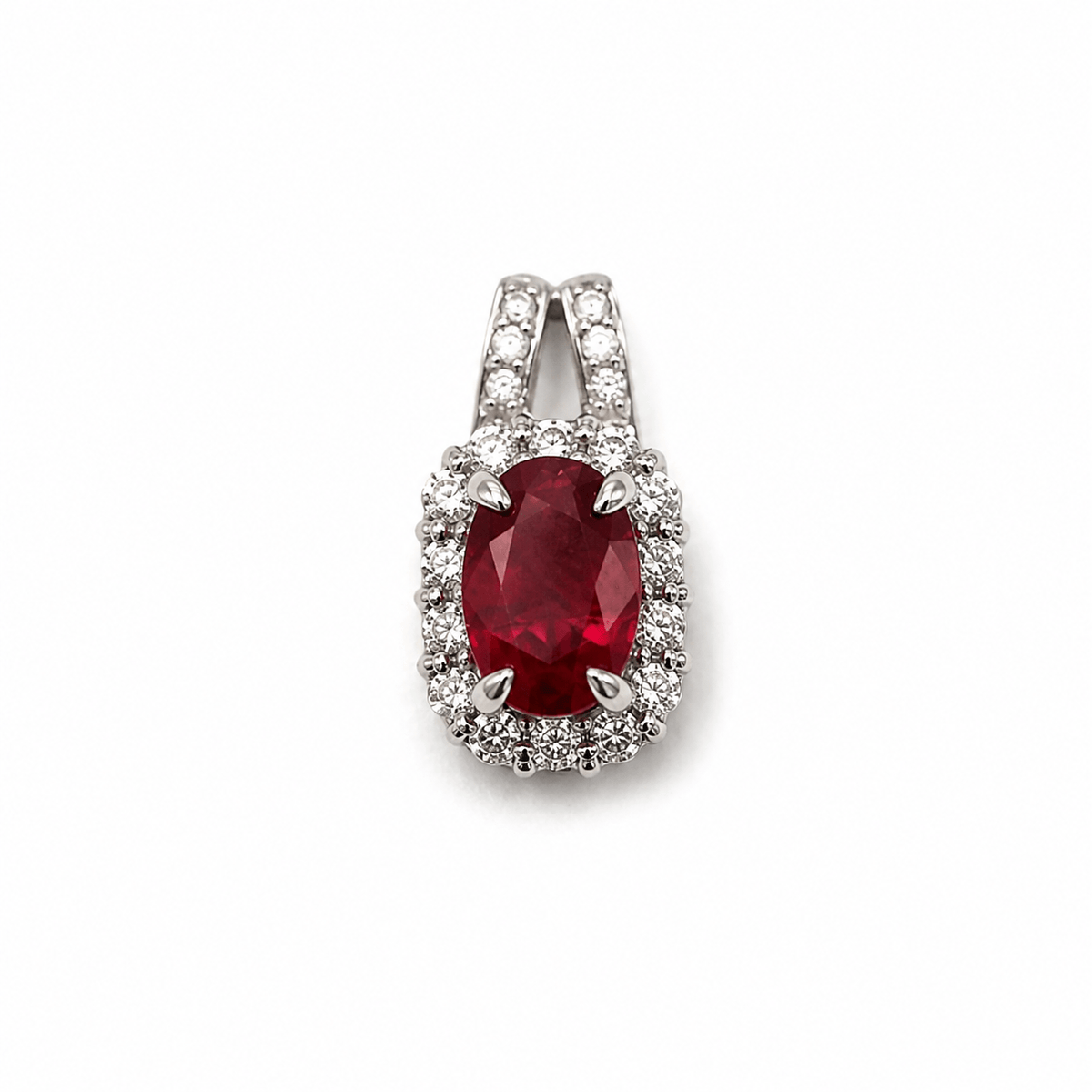 Oval ruby and diamond halo pendant in white gold by EMBLUME